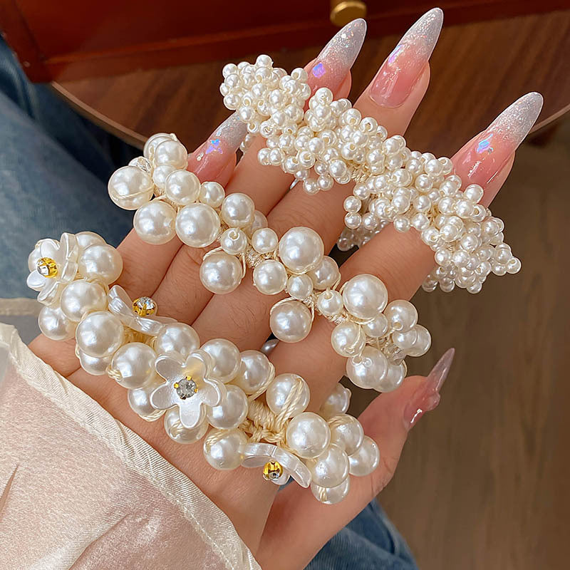 Pearl hair accessories held in a hand with a blurred background